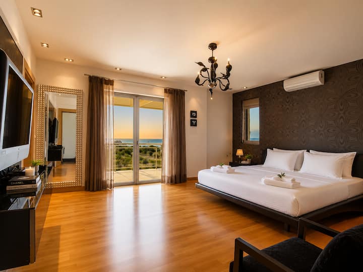 Main Level - Master Bedroom 1 featuring a king-size bed, walk-in wardrobe, and a luxurious ensuite bathroom with a Jacuzzi bathtub and walk-in rain shower