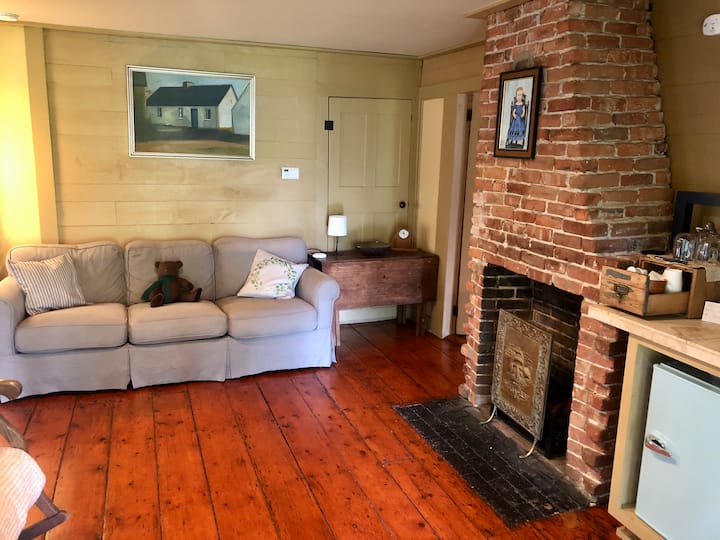 Comfortable couch and a coffee bar with microwave and mini fridge. This area is adjacent to our kitchen, separated only by locked doors. Privacy is limited.