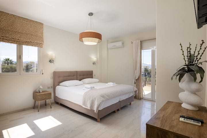 The third bedroom on the first floor with a king-size bed (1.80 x 2.00), a TV, a closet, and a private balcony.