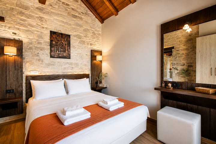 Master Bedroom with a queen-size bed, ensuite bathroom with walk-in shower, and direct access to the pool terrace.