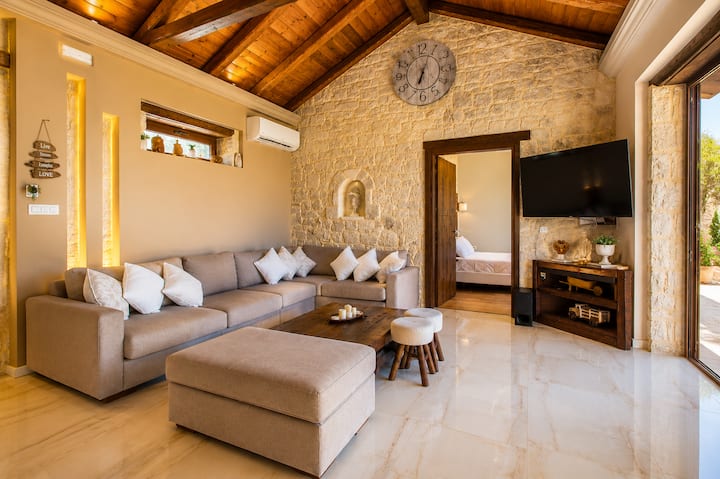 Bright Open-Plan Living Area with comfortable seating, Smart TV, breathtaking sea views, and direct access to the terrace and pool.