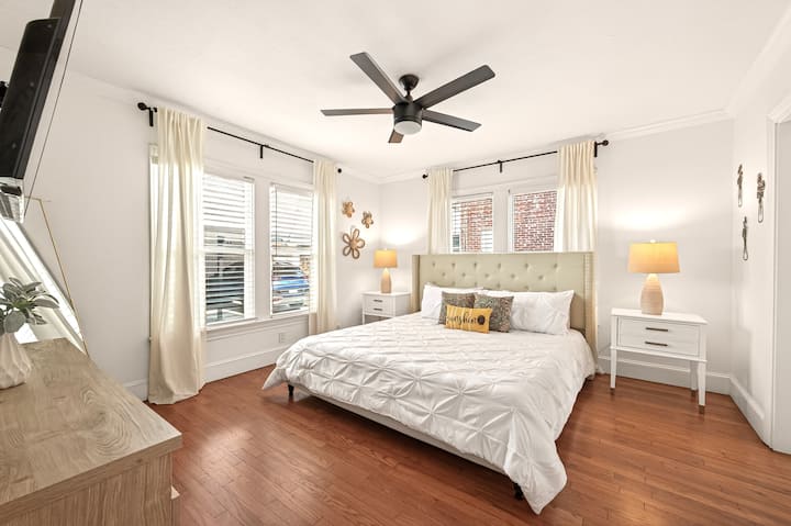 Spacious Bedroom 2 at KingBedsOnly 1714 Fairview features a comfortable king bed, 65" Roku Smart TV, hardwood floors, a closet for hanging clothes, and plenty of natural light—ideal for relaxing stays.