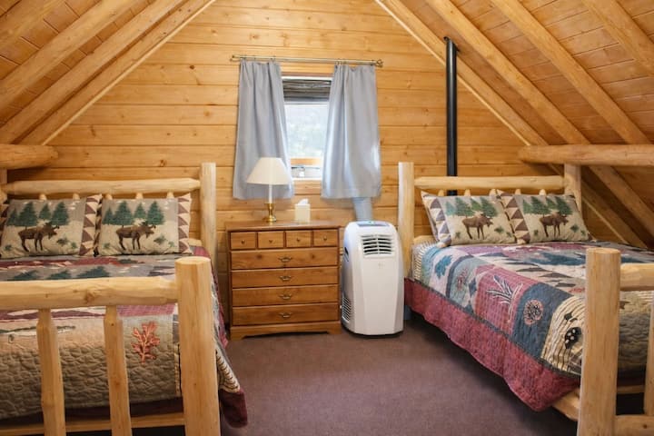 Spacious loft bedroom featuring two cozy queen beds