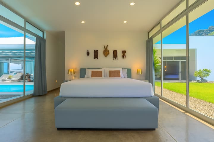 Spacious master suite featuring an en suite spa-style bathroom, walk-in closet, air conditioning, and stunning views of the ocean and pool. Relax in your private hammock and soak in the serene tropical ambiance.