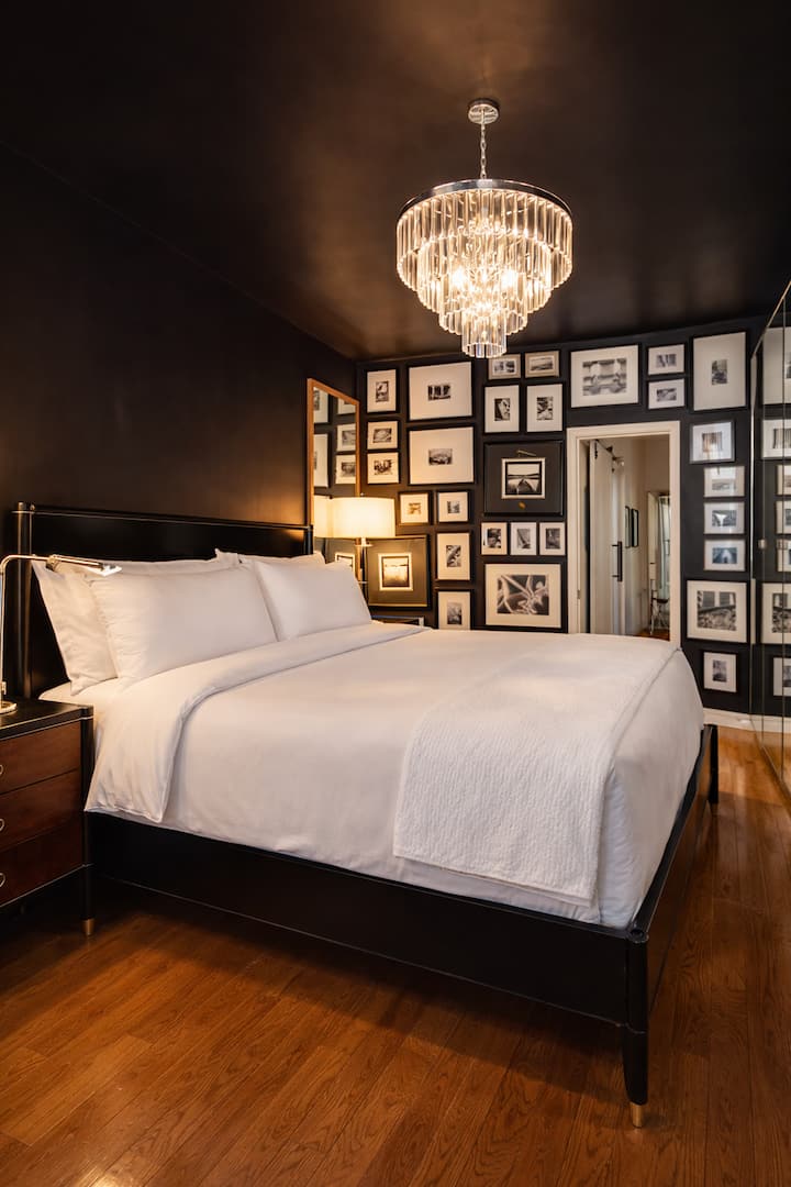 Ralph Lauren inspired bedroom with designer Restoration chandelier and Ralph Lauren leather lighting and Sterns and Foster king sized mattress. Finished with Italian Percale cotton sheets for a crisp night sleep