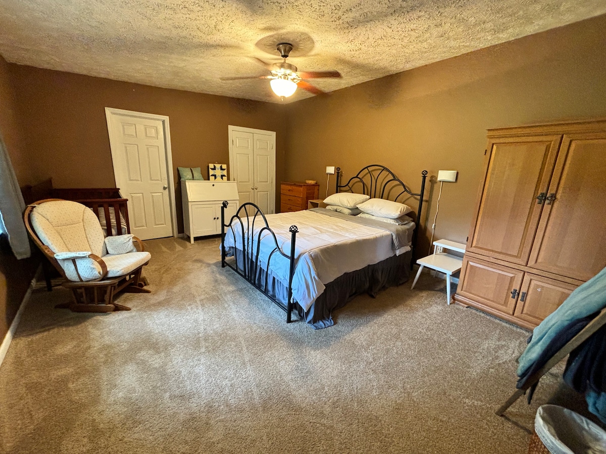 Bedroom 1 with very cozy bed, dresser, desk, and crib if needed. 
