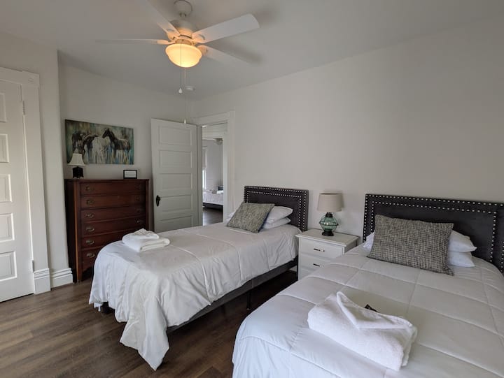 Bedroom 3 has 2 twin beds, dresser, closet, shared nightstand and 2 luggage racks