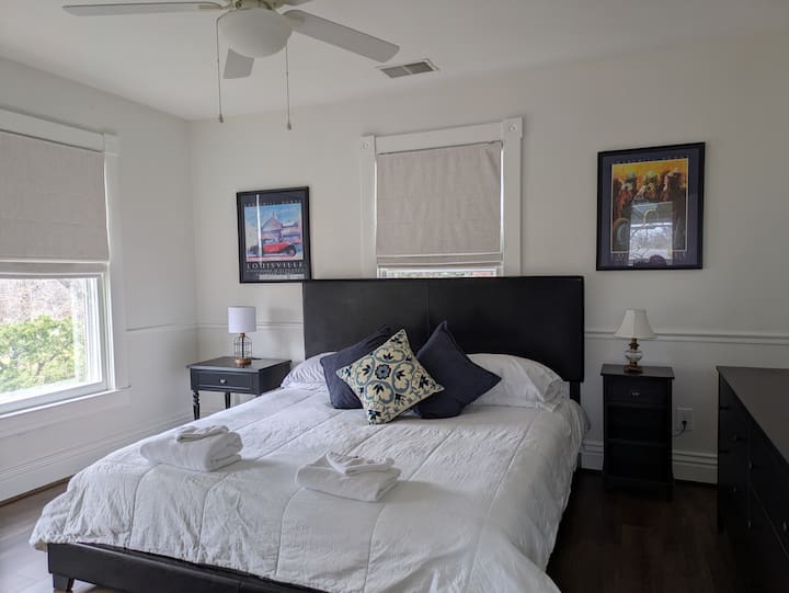 The primary bedroom has a king bed, dresser, nightstands, 2 luggage racks and a closet