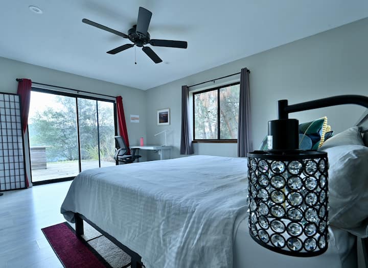 Master Bedroom — King bed + far-off mountain views. Settle into a roomy king bed and wake up to mountains stretching out in the distance… the kind of view that makes mornings feel a little softer and a lot more special
