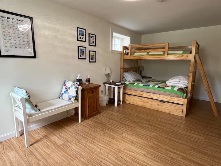 Basement guest room (bunk beds w/trundle bed). Full size bottom bunk, twin pull-out trundle and twin top bunk. Luggage rack and closet in the room. Pillows, linens and blankets (inc. down comforter) provided. Roku smart TV. Variety of games.