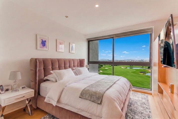 Master Bedroom with Incredible view of the golf course and 65' LED Smart TV.  King size bed with luxurious Four Seasons mattress.