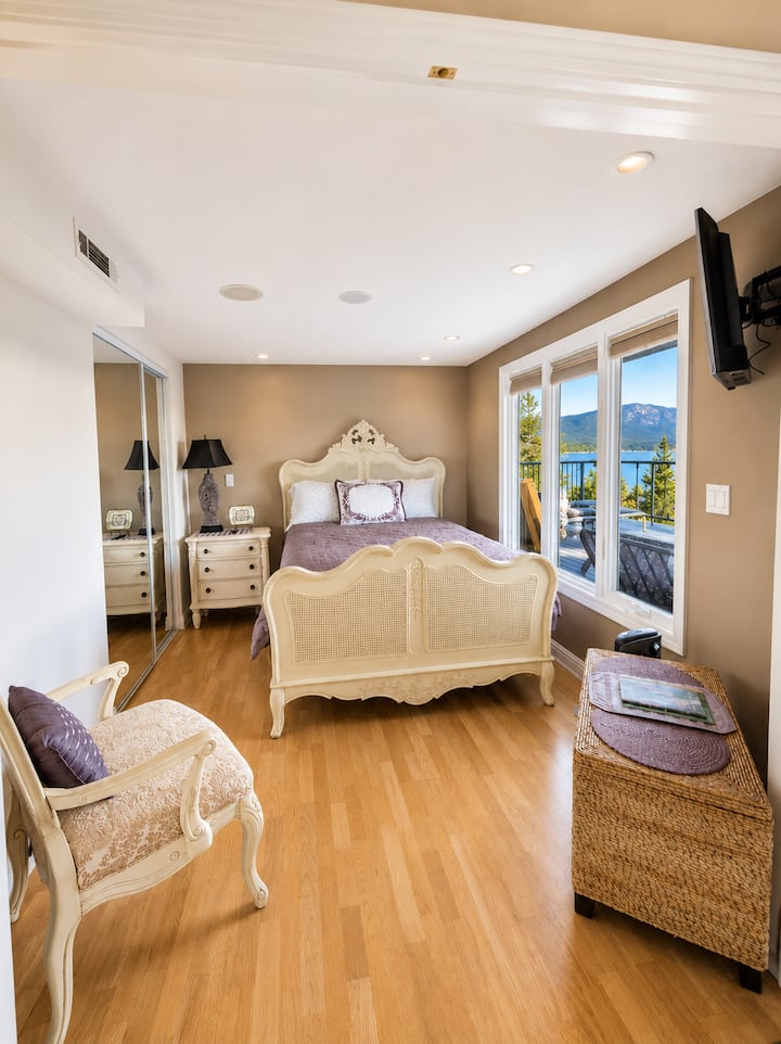 Private downstairs bedroom with one queen bed, offering a quiet enclosed space with added privacy. Located on the lower level near the full bathroom and easy access to the lower deck and hot tub