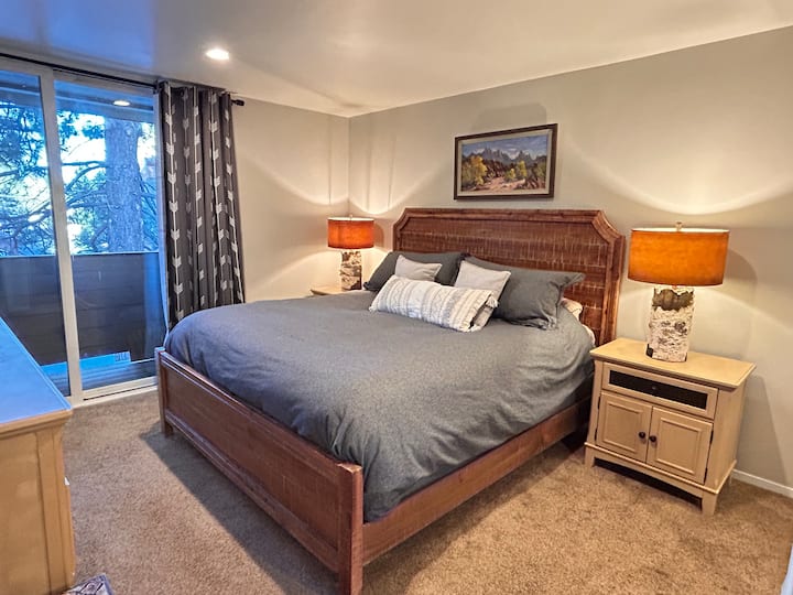 Downstairs bedroom features a king bed with luxury mattress, down comforter, room darkening shades and balcony access. 