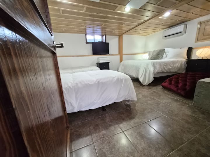 Bedroom 4 in the basement with 1 soft double bed and 2 firm single beds 
