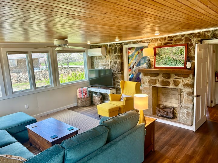 2nd living room at the rear of the house. This room is full of windows & looks out on the expansive backyard.  The sectional couch converts to a double bed, & the room can be sealed off for privacy to be used as a 3rd bedroom.  Full bath room ensuite