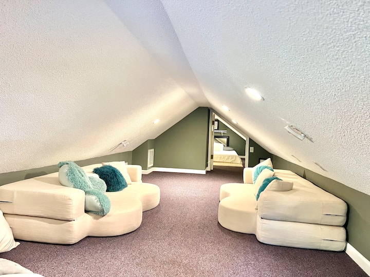 Finished attic space. 2 fold out sofa beds and a separate room w queen. 5 foot tall at center.  