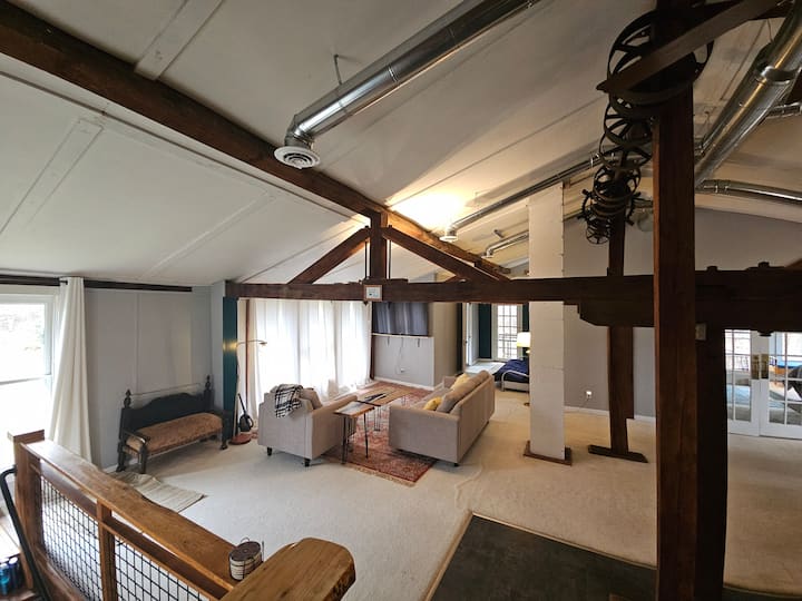 Spacious living area with a birds eye view of the grounds and creek.
