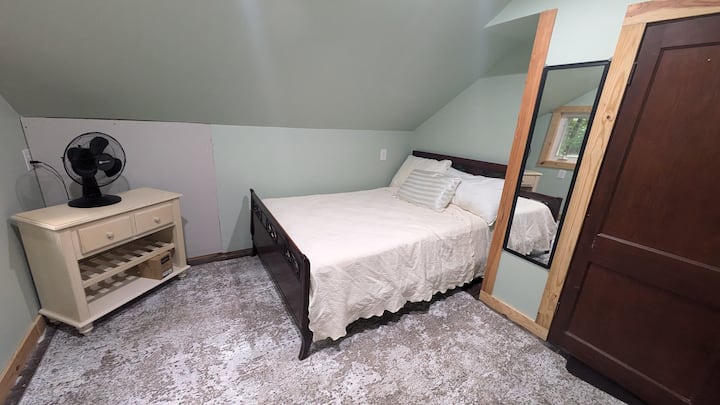 This Bedroom provides the most serene view of the pines. The sun rises on the other side of the house and provides a soft morning glow to wake up. The full bed is tucked into the corner is private and cozy.