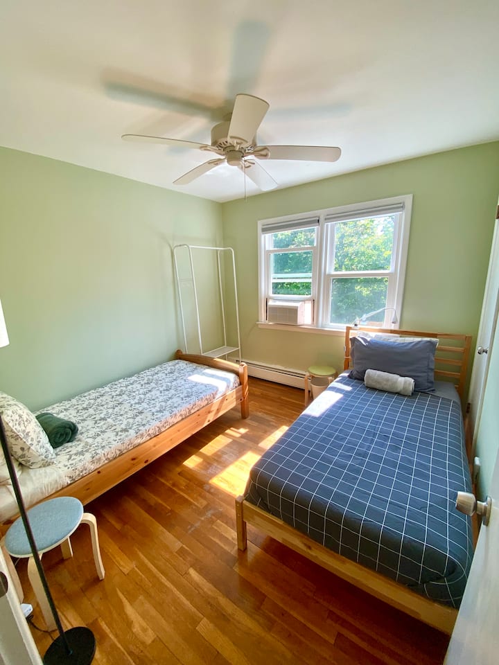 Bedroom #3: Two single beds with clothing rack/storage.