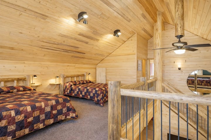 Bedroom 4 is an open loft upstairs with three queen beds. 
