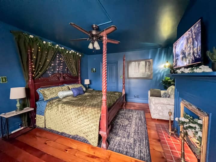 Moody king suite with canopy bed and rich character with private en suite bathroom and private livingroom.