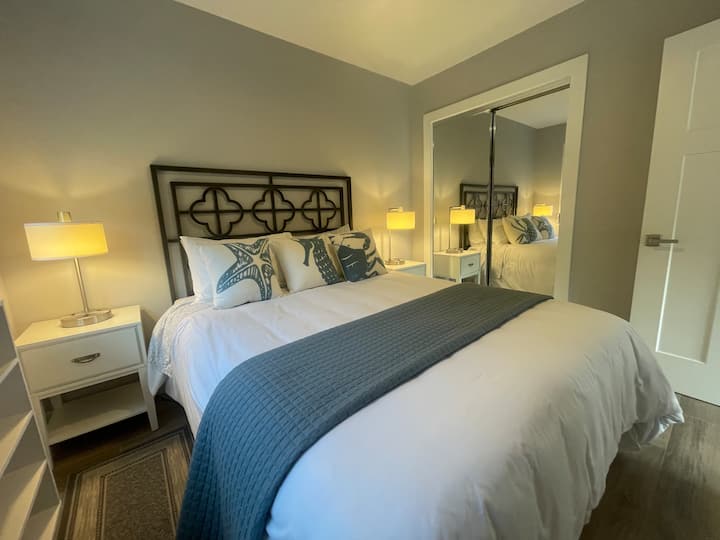 - Queen bed
- Memory foam mattress
- Room darkening shades
- Lamp bases have USB and 2-prong charging options.
- Luggage rack