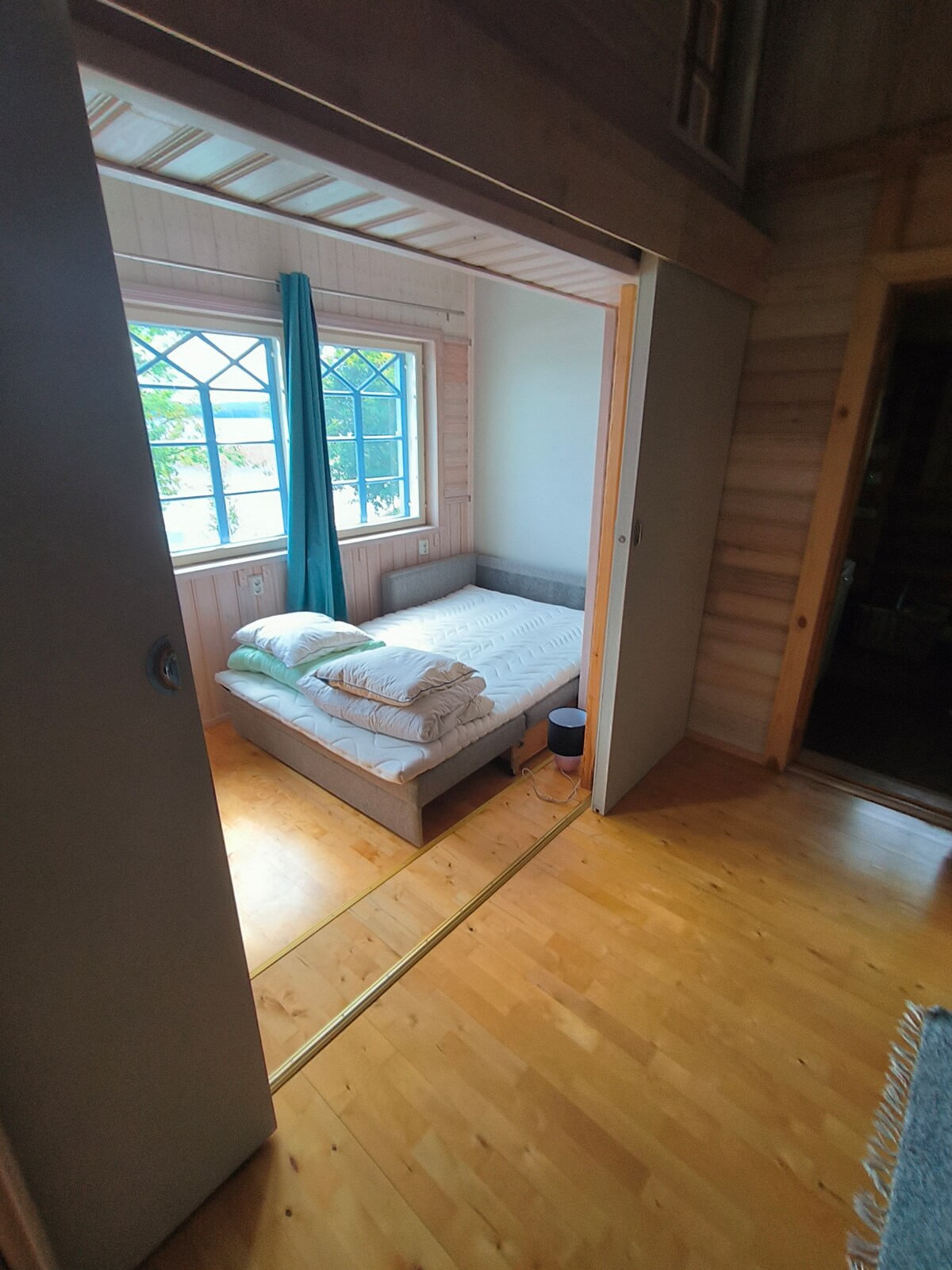 ห้องนอนที่มีประตูบานเลื่อนพร้อมโซฟาเบดกว้าง 140 ซม.