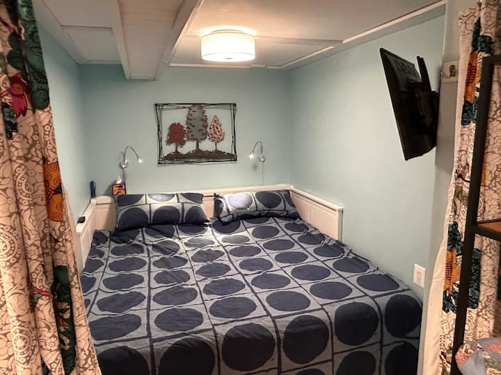 King size bed in quiet nook with curtains
