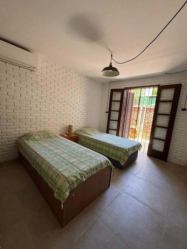 The room has: 1 single bed + 1 "3 in 1" bed. 
The 3-in-1 bed can be 1 single bed when closed and, when open, it can be 1 queen bed OR 1 single bed with 1 trundle bed