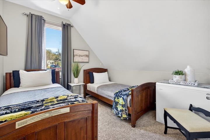 Upstairs twin room designed for family stays — giving everyone their own space.