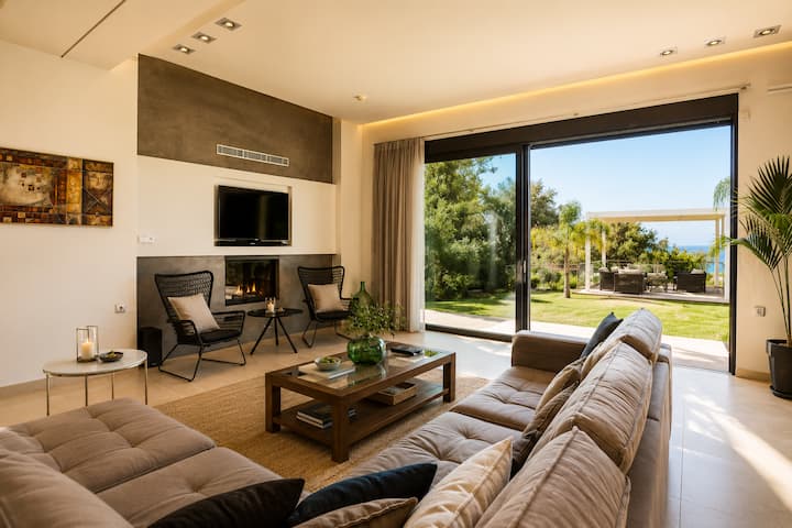  Ground Floor - Open-plan living area with a 55” satellite HDTV, fireplace and garden access