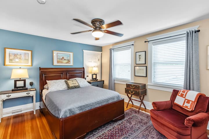 Our Fireside Suite shows off the original trim, fir floors and the gorgeous Bidjar hand-woven rug. This queen suite offers a private full bath, EFI fireplace, walk-in closet, streaming TV, iron, ironing board and comfortable club chair.