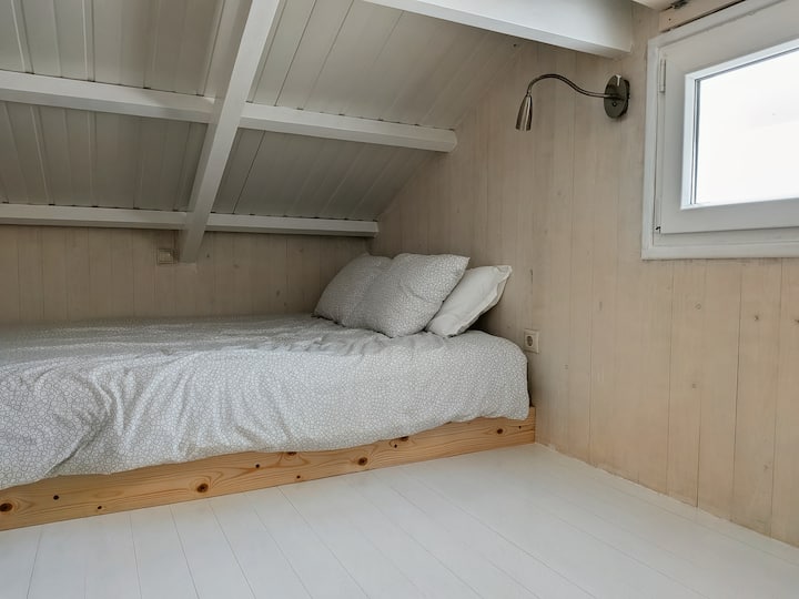 In the low-ceiling mezzanine. The bedroom with a double bed.
In the mezzanine, which has a low ceiling. The bedroom with a double bed.