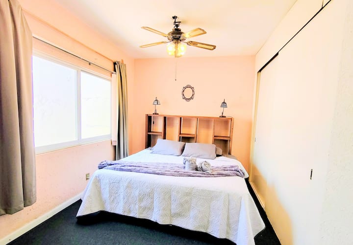 Dormitorio principal con cama tamaño king y luz natural.