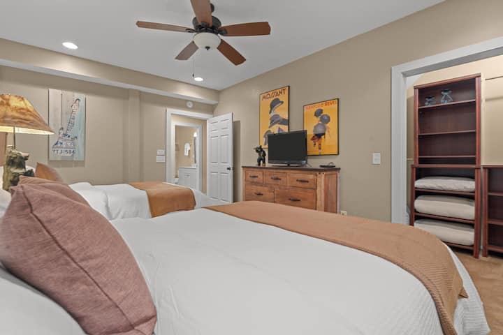 Relax in comfort with two plush queen beds, beautifully dressed in luxurious, hotel-quality bedding for a restful night's sleep.