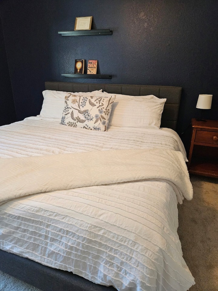 King bed with workspace and room darkening curtains. 
