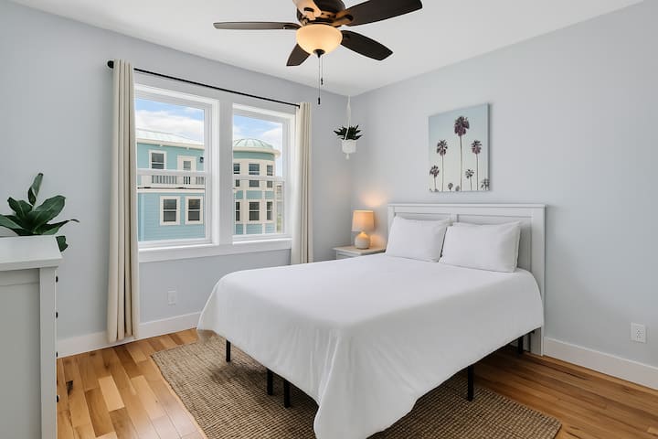 This bright upstairs bedroom houses a queen bed with super soft bedding and a premium Muse memory foam mattress