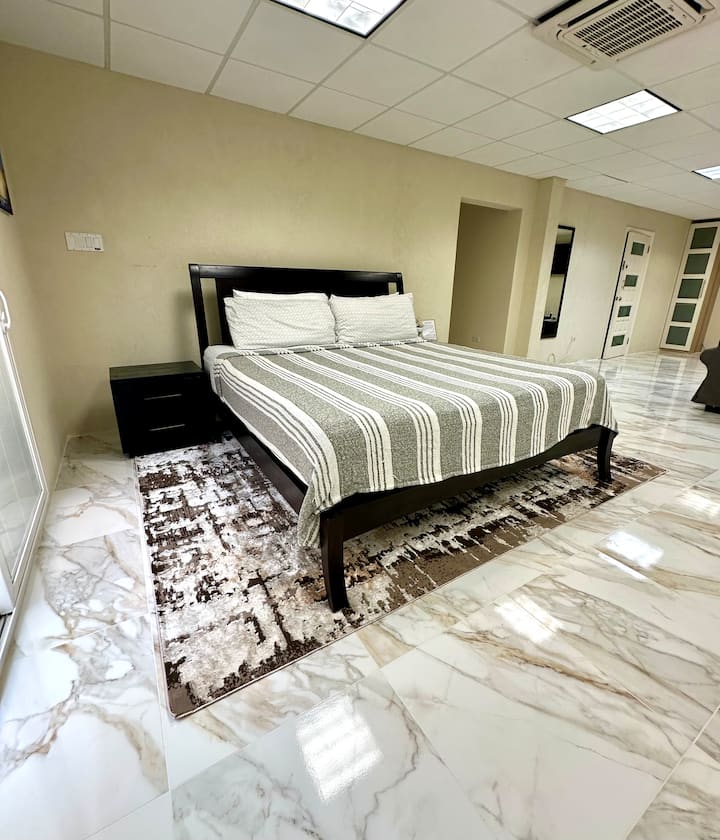 Additional 4th room - Spacious private suite with king bed, smart TV, fridge, and ensuite full bathroom
