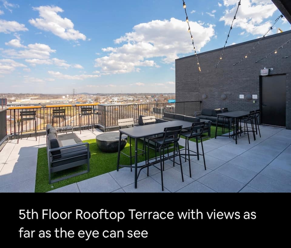 Shared rooftop terrace with twinkling lights and skyline view