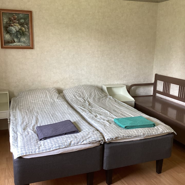 The bedroom has two beds that can be separated or put together as a double bed as needed, and an old wooden sofa where you can make a bed for a child, for example, if necessary.