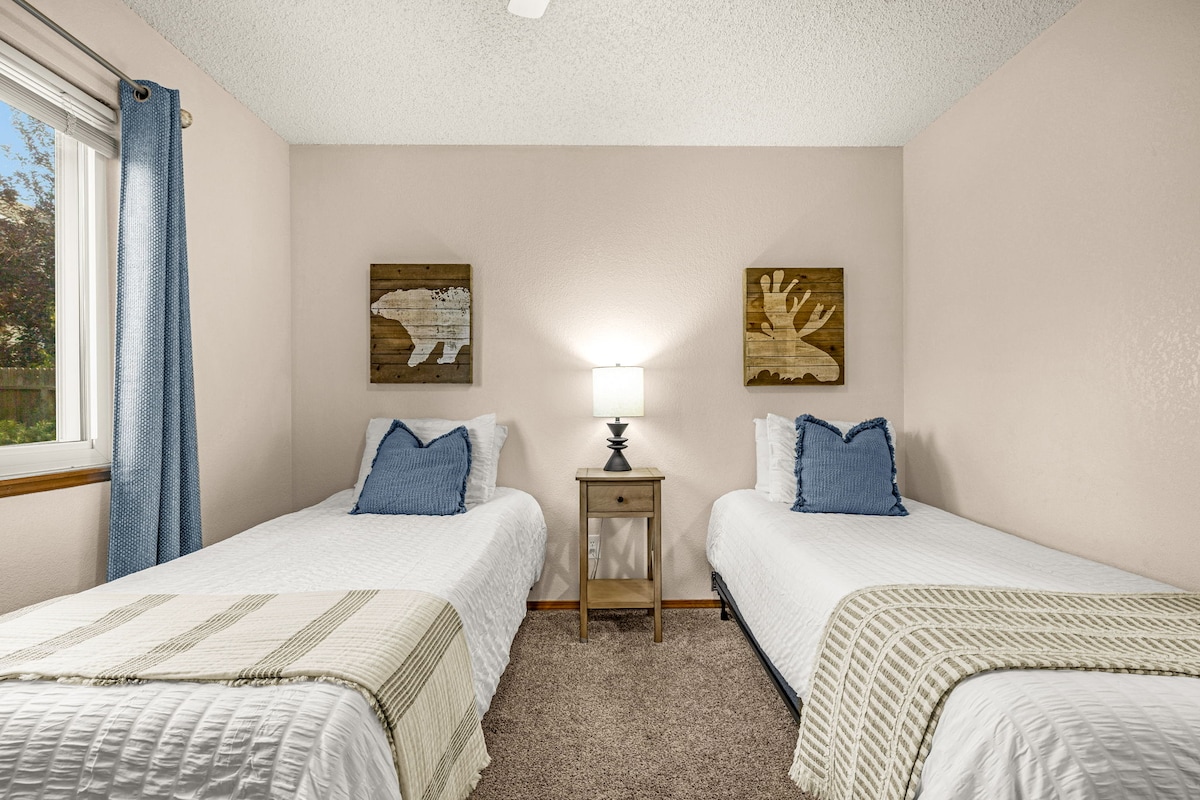 Bedroom on the first level with two twin beds, a closet, and Bathroom 1 conveniently just outside.