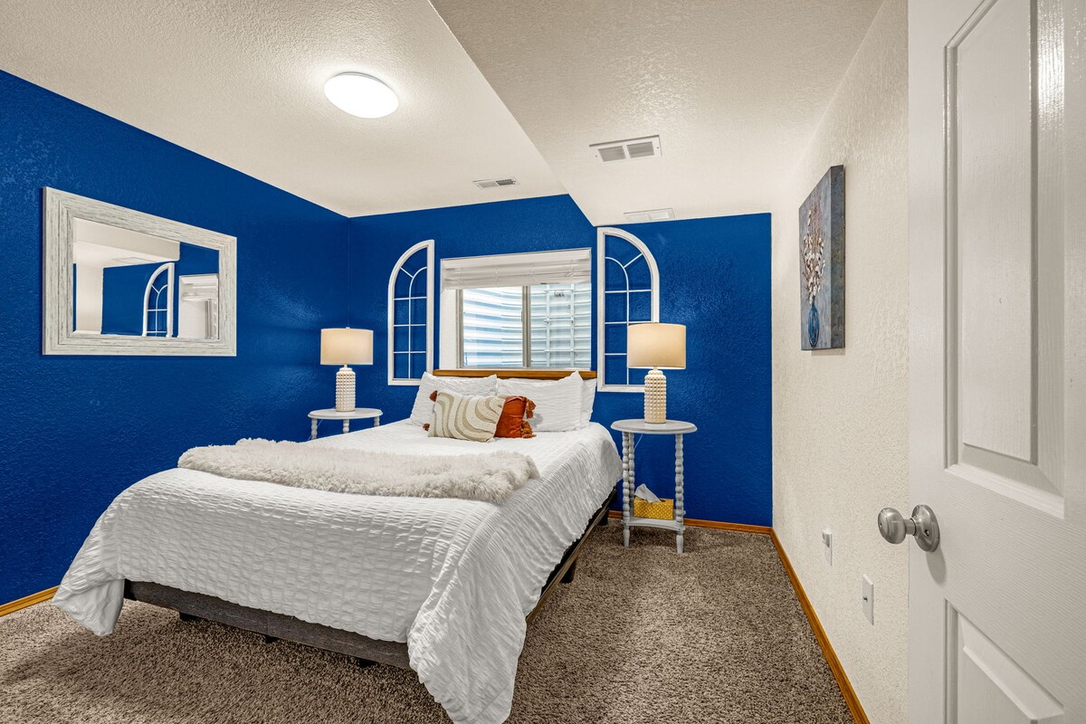 Lower level bedroom with a queen bed, a closet, conveniently located near Bathroom 2 in the same hallway.