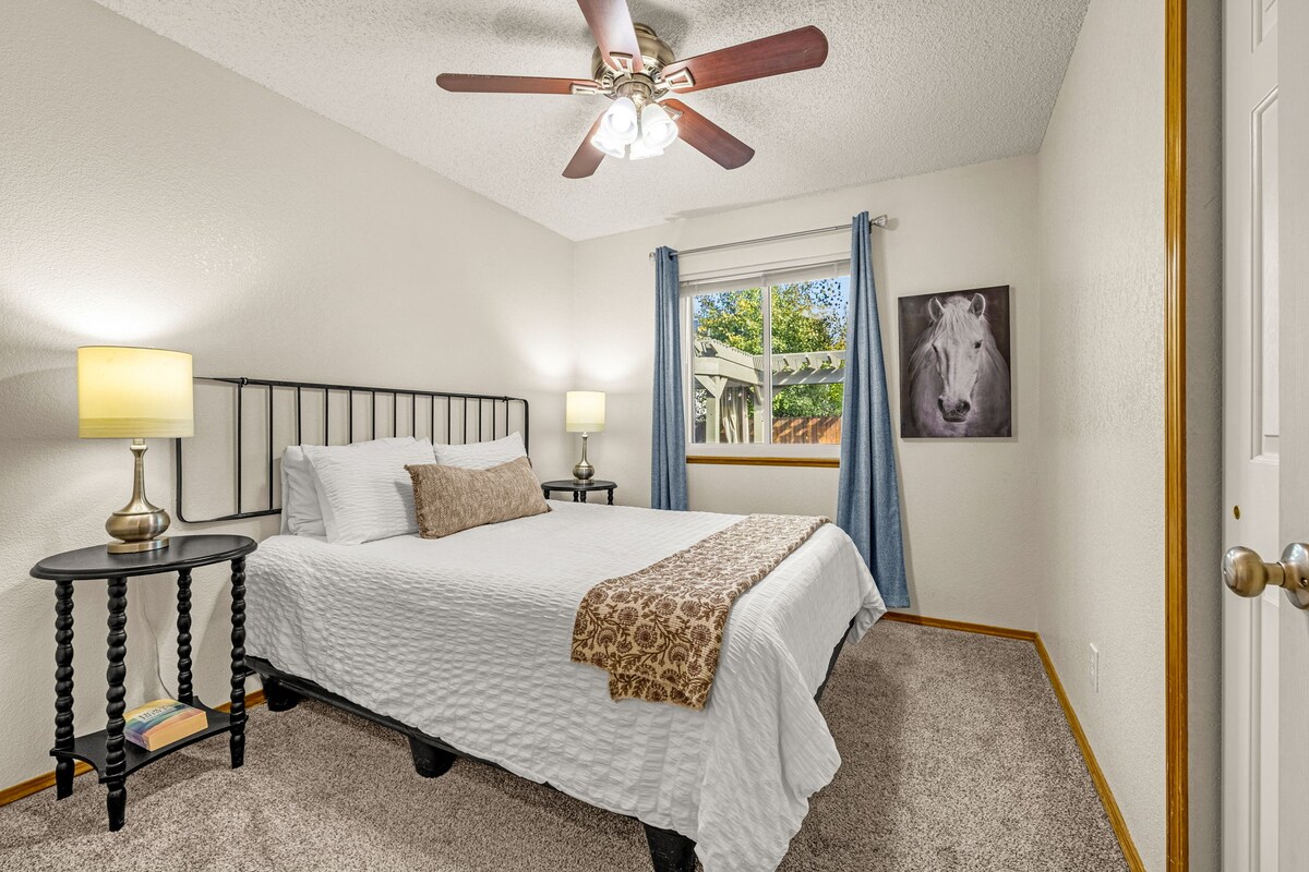 Bedroom on the first level with one queen bed, a closet, and Bathroom 1 conveniently just outside.