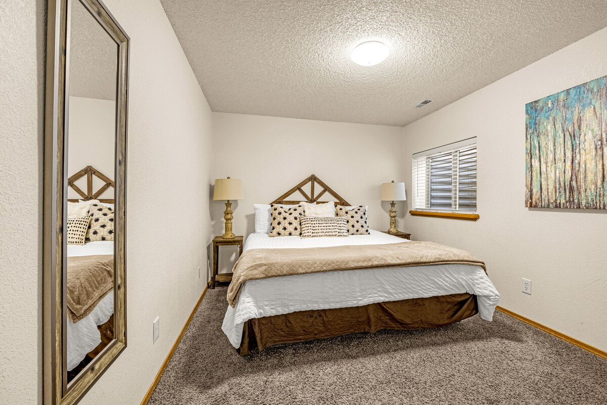 Lower level bedroom with a king bed, a closet, conveniently located near Bathroom 2 in the same hallway and just outside the living area. 