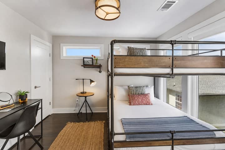 Let the kids call the bunk room before the adults finish unloading — queen over queen, industrial-style frame, and enough space for four to sleep comfortably.