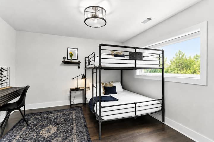 Pick a bunk, open the laptop, and you're done — the second bunk room doubles as a workspace so someone can actually get things done