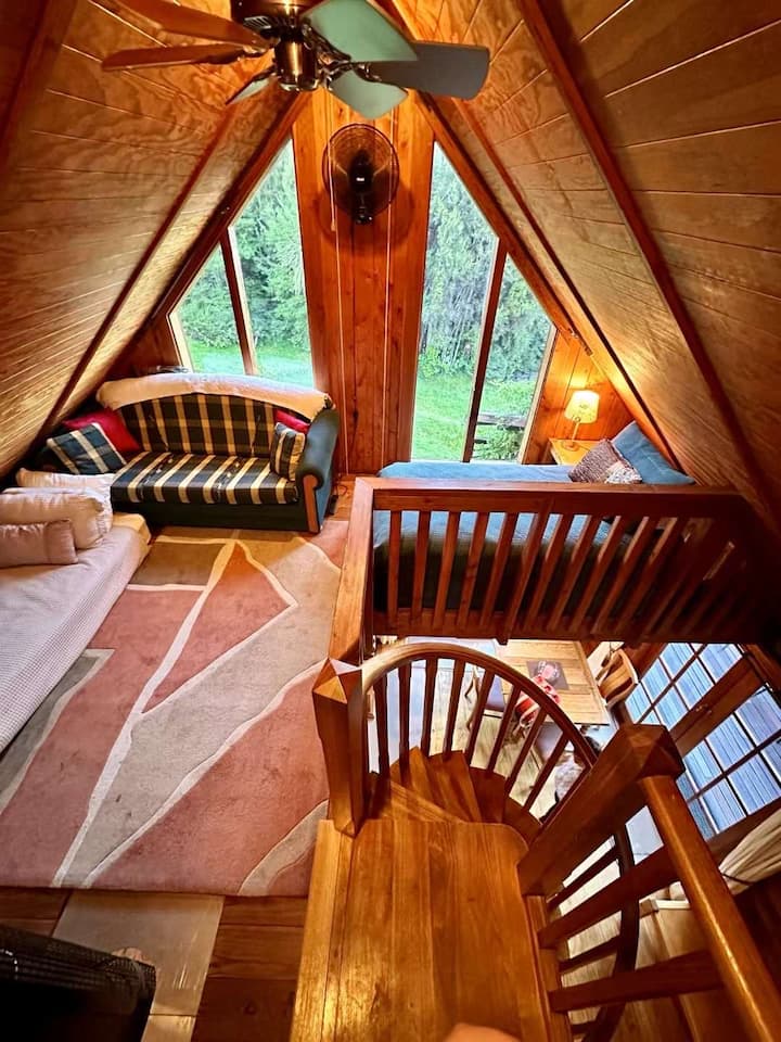 Our special mezzanine area with great single bed enjoying super mountain views, snug single mattress on the floor, and long relaxing couch