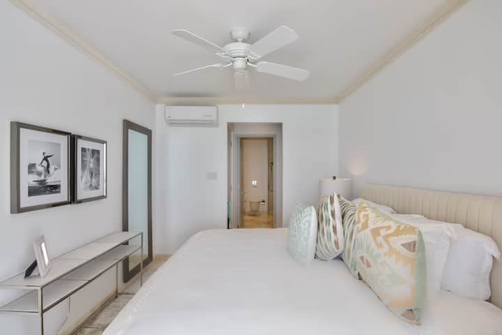 Bedroom 2 with a king size bed (US), ensuite shower room, security safe, air conditioning, bath robes, hair dryer and a balcony with sea views.