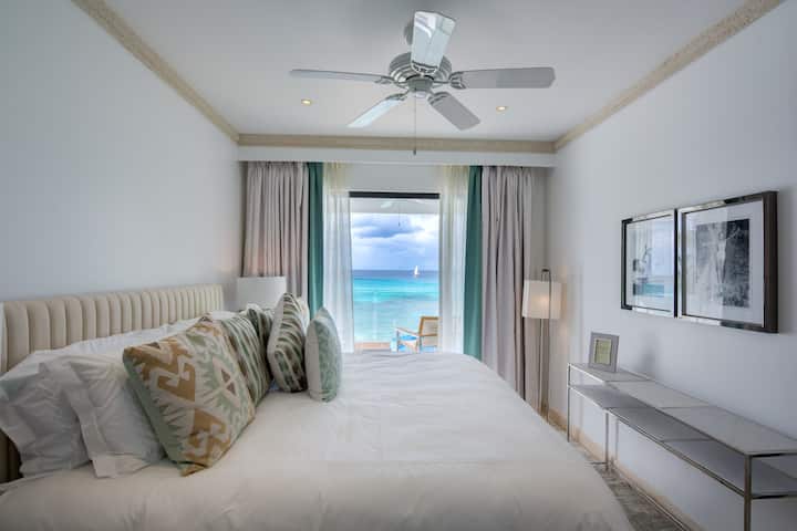Bedroom 2 with a king size bed (US), ensuite shower room, security safe, air conditioning, bath robes, hair dryer and a balcony with sea views.