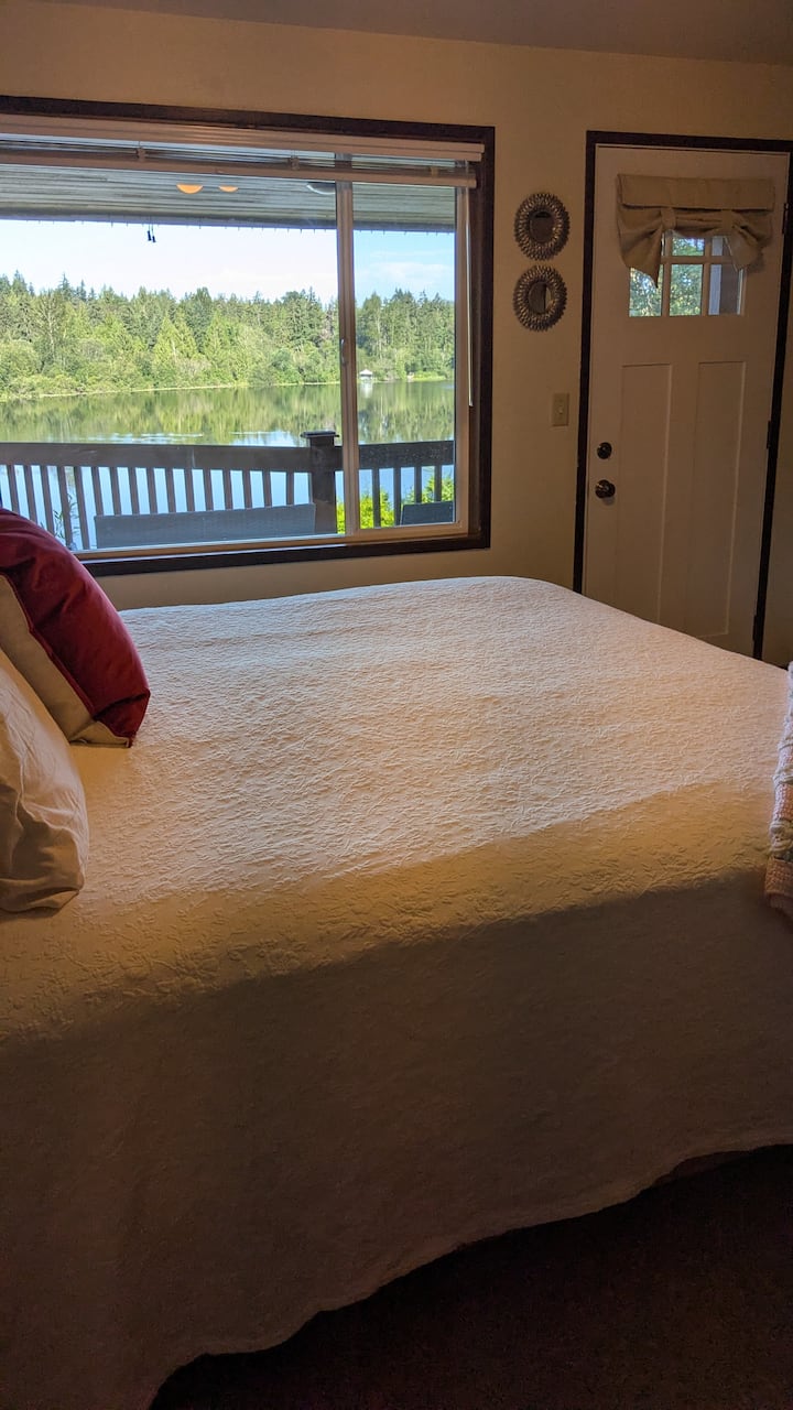 Master bedroom is first on the left with a beautiful King bed. You can see the view with a door to the covered deck.
